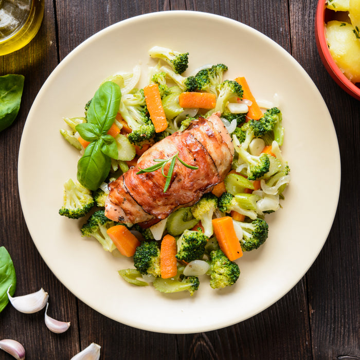 Chicken breast wrapped in bacon with mixed vegetables